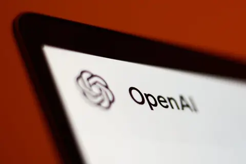 OpenAI logo on a glass office building, photographed from below