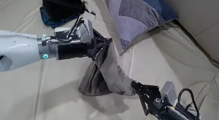 LongLive 2.0 Robot video model imagining a robot folding clothing, from the Long-WAM demos